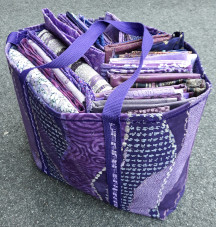 Purple tote bag chock full of purple fabrics.