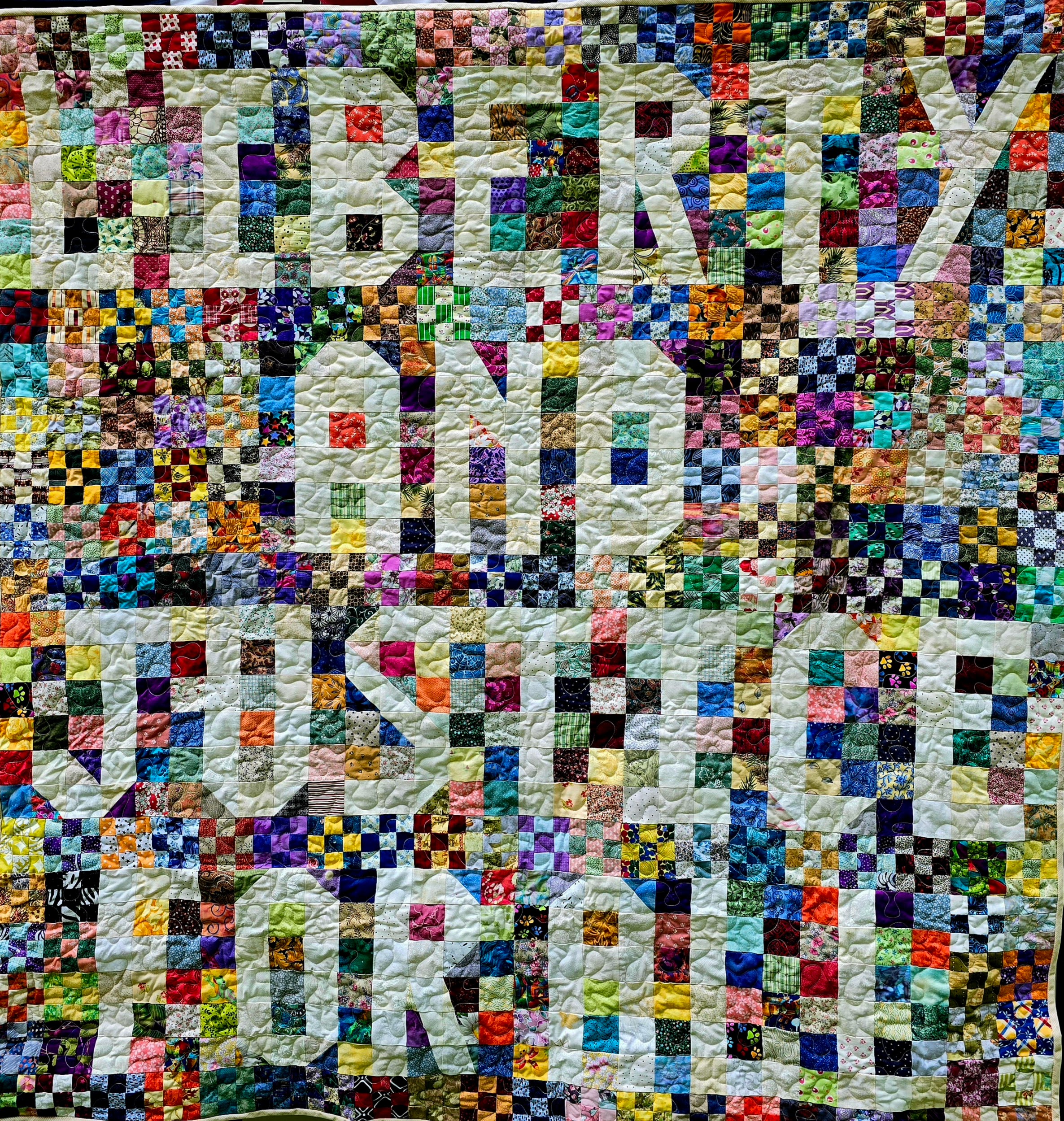 Patchwork quilt which says LIBERTY AND JUSTICE FOR ALL